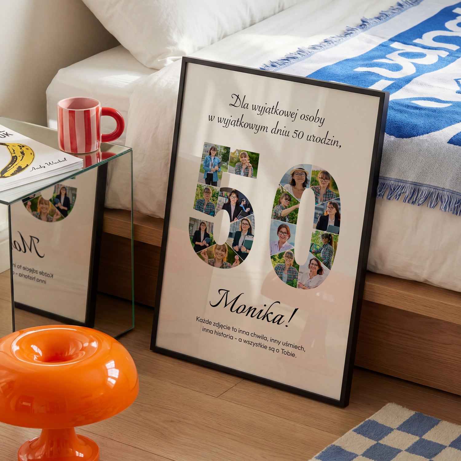 Personalizowany plakat na 50 urodziny w czarnej ramce z 16 zdjęciami w kształcie cyfry 50 i imieniem Monika obok łóżka